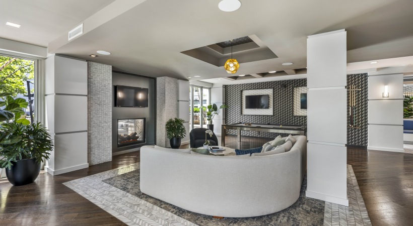 Resident lounge with couch, TVs, fireplace, and pool table