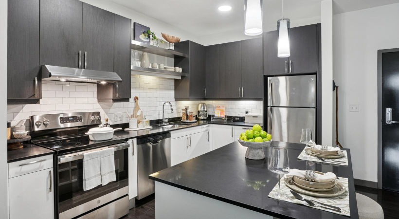a kitchen with black cabinets